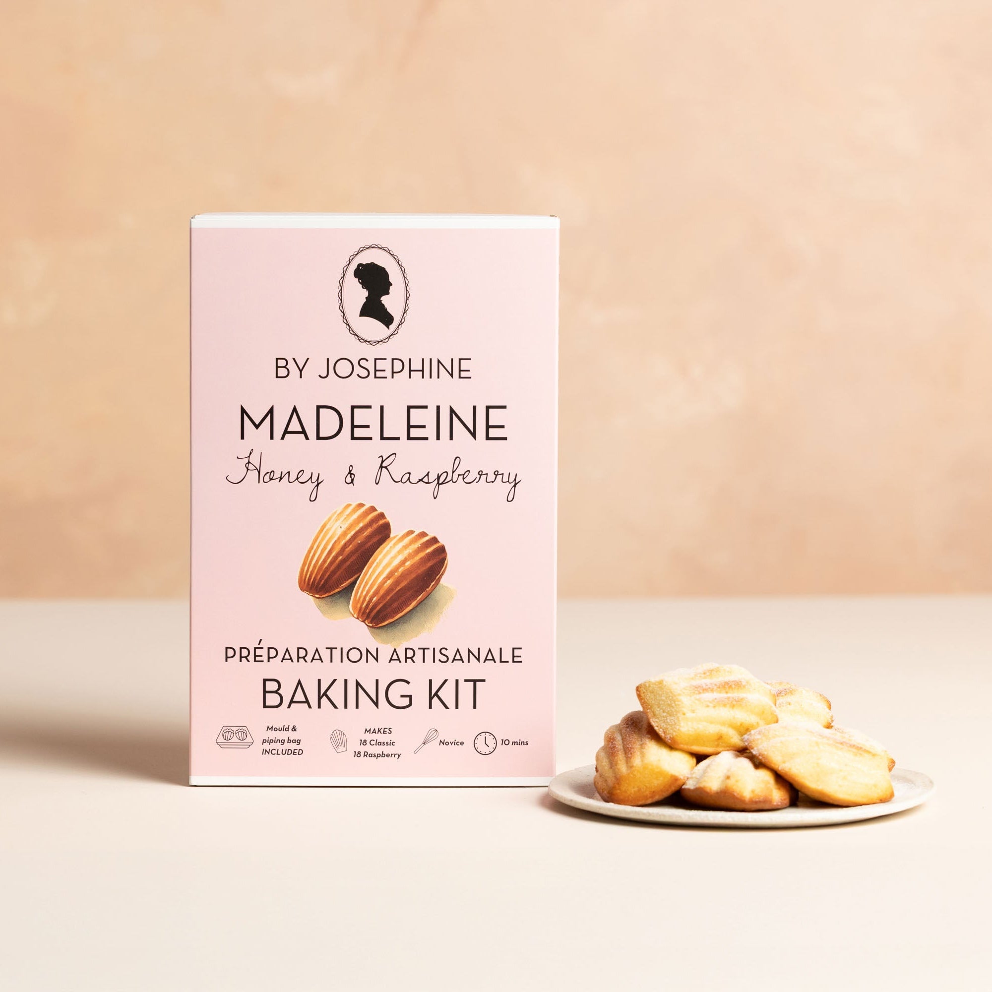 Baking kit packaging with madeleines on a beige background