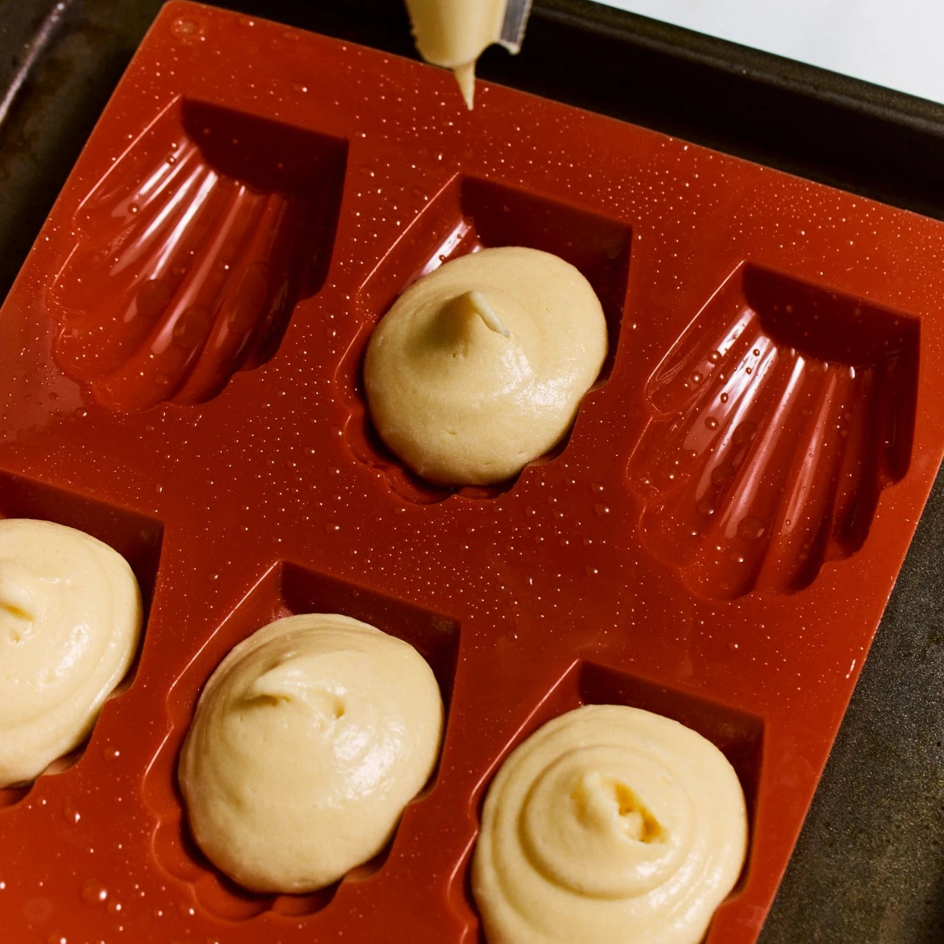 Silicone mold with batter being poured into it