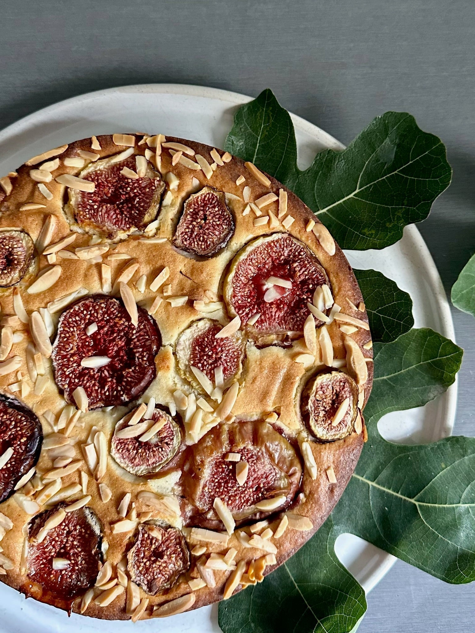 Fig, almond and yoghurt tea cake with ripe fresh figs and flaked almonds, styled for autumn baking in Melbourne by By Josephine